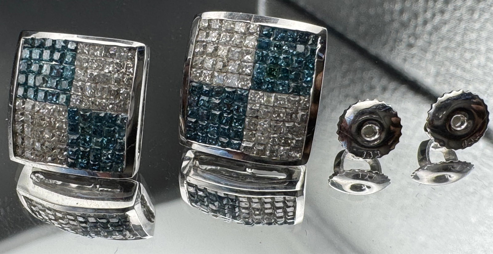 14K WHITE GOLD BLUE WHITE PRINCESS DIAMOND CLUSTER STUDS 1.90CT: 14K white gold diamond cluster stud earrings featuring 1.90ct earth-mined princess cut diamonds, G color, VS2/SI1 clarity, invisible set. 50 blue and 50 white diamonds per earring. Screw-back closure.