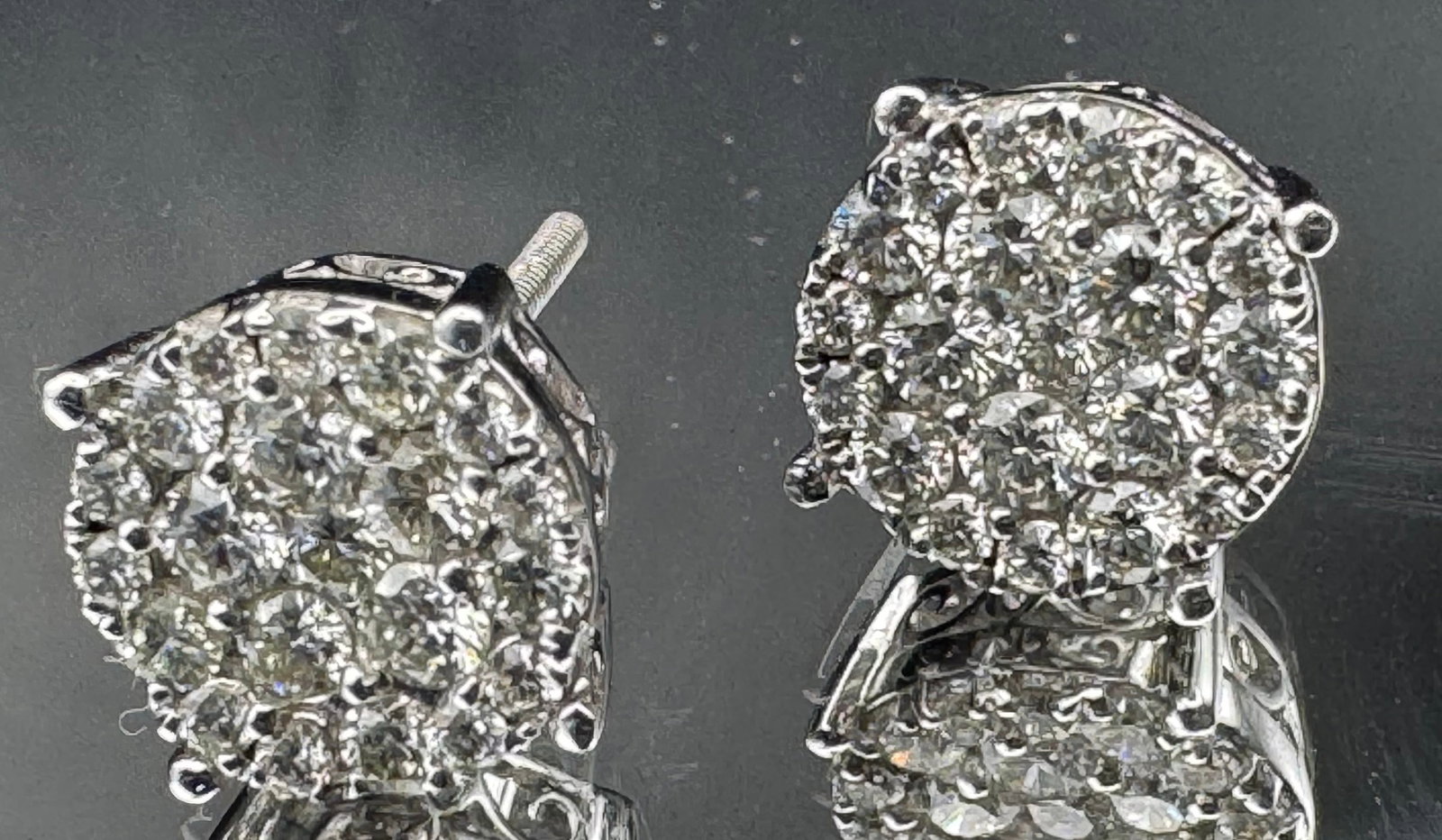 14K WHITE GOLD DIAMOND CLUSTER FLOWER STUD EARRINGS 1.00CT: 14K white gold diamond cluster flower stud earrings featuring 1.00ct round brilliant cut earth-mined diamonds, G color, VS1/SI1 clarity, prong set. 20 diamonds per earring. Screw-back closure. Total w
