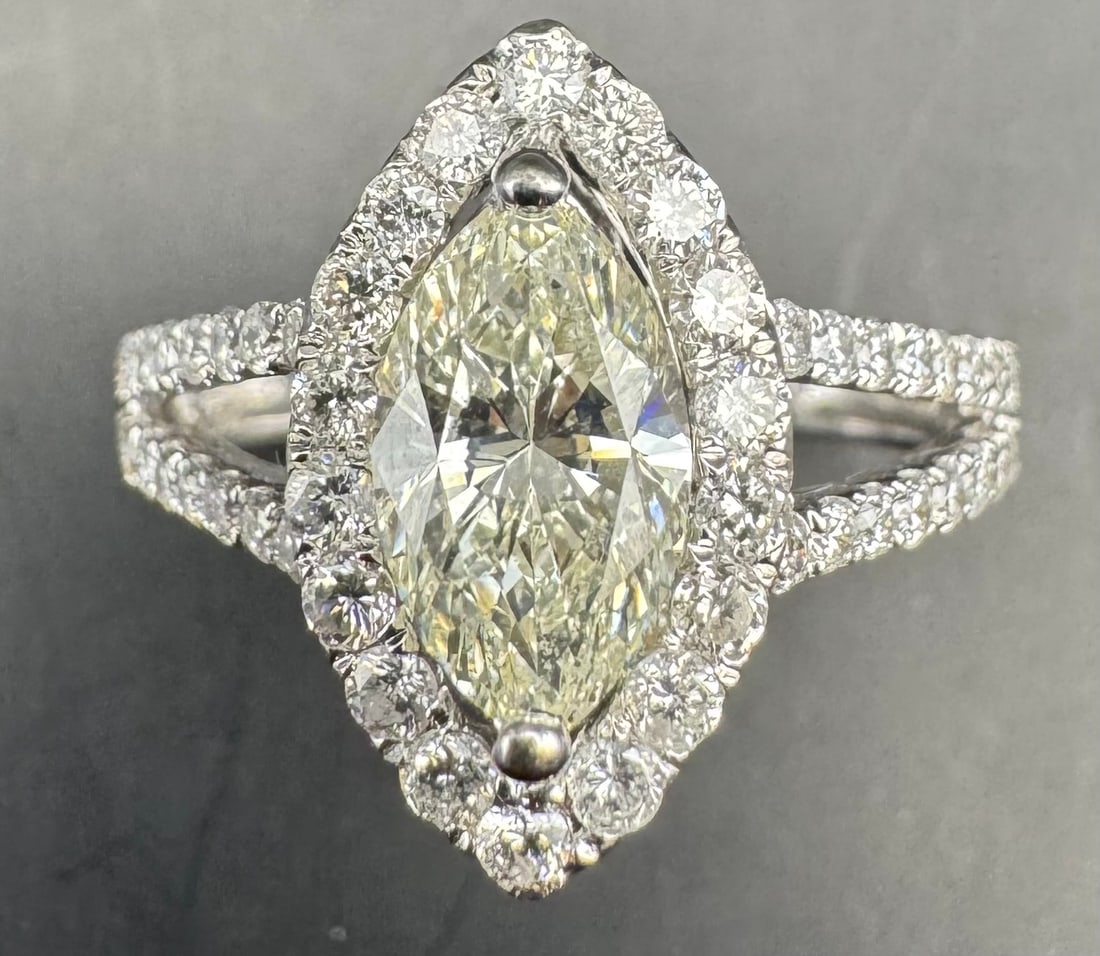 14K WHITE GOLD MARQUISE DIAMOND RING 2.31CT: 14K white gold ring featuring a 1.30ct marquise cut earth-mined diamond center stone, J/K color, VS2/SI1 clarity, set in 2 prong setting. Side stones feature 1.01ct round brilliant cut earth-mined dia