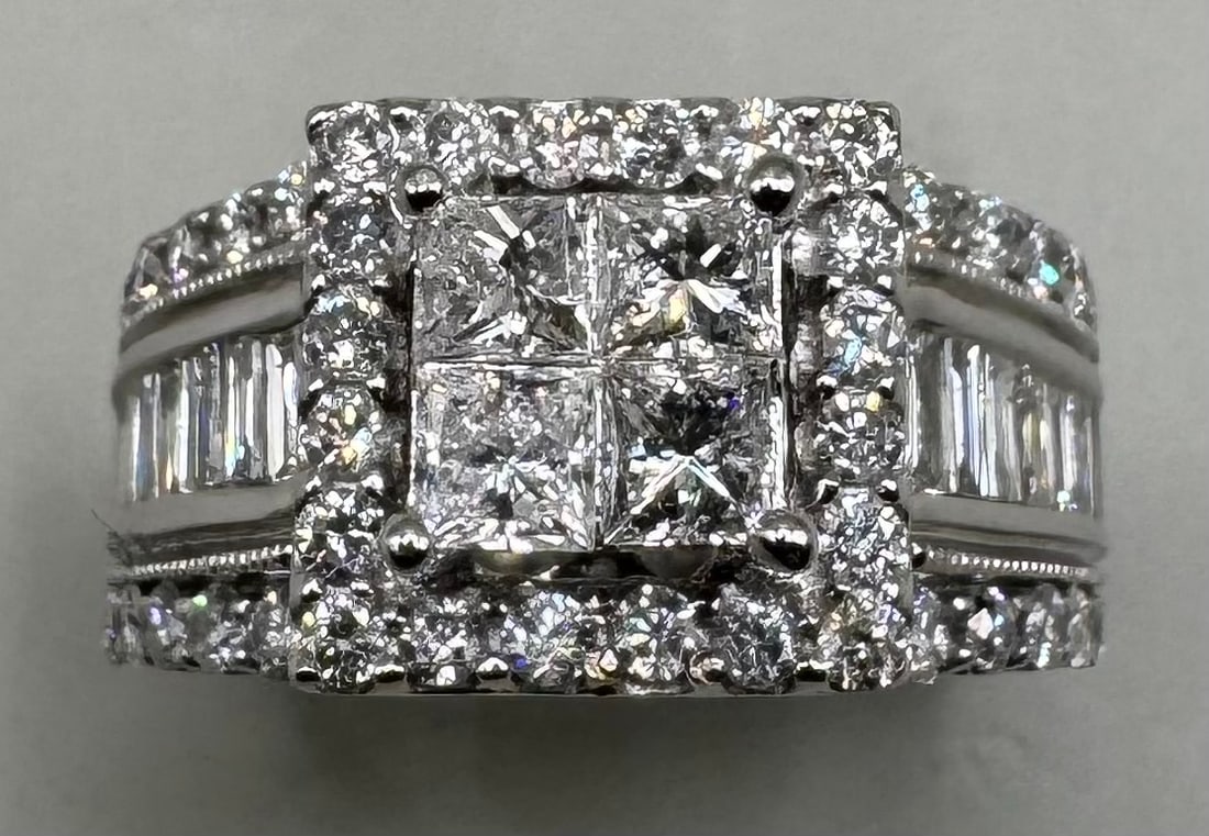 14K WHITE GOLD PRINCESS CUT DIAMOND RING 2.25CT: 14K white gold ring featuring princess cut earth-mined diamonds in invisible cluster center setting, G color, VS2/SI1 clarity. Surrounded by round brilliant cut diamond halo and baguette side diamonds
