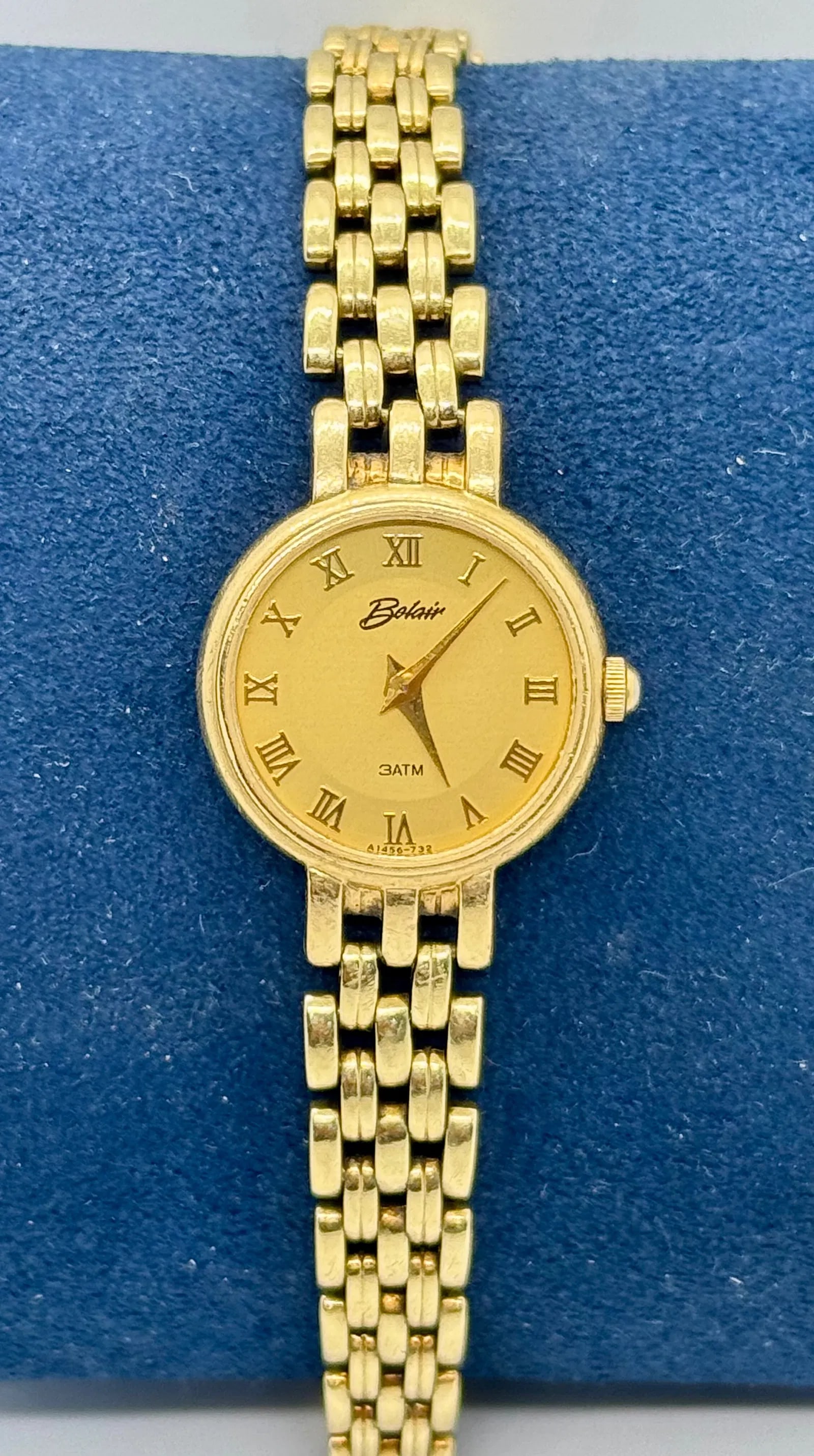14K YELLOW GOLD BELAIR MOTHER OF PEARL WATCH: Exquisite 14K yellow gold Belair wristwatch featuring a classic mother of pearl dial and a sophisticated panther link bracelet. The watch is engineered for durability with ATM water resistance and a s