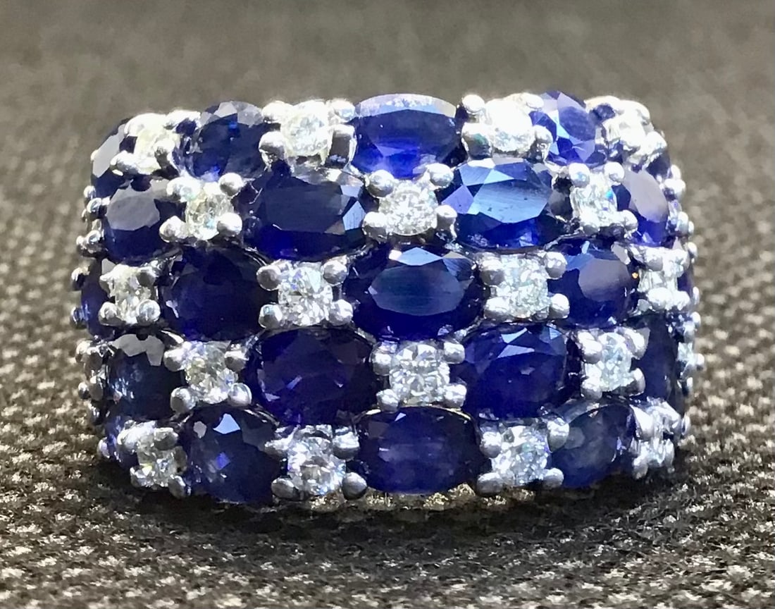 14k White Gold 4.00ct Royal Blue Sapphire & 1.00ctw Multi-Stone Diamond Ring (8.9g): This stunning 14k white gold ring offers an artistic and high-impact design featuring a magnificent 4.00-carat genuine oval-cut Royal Blue Sapphire. The deep, rich blue of the sapphire serves as a bre