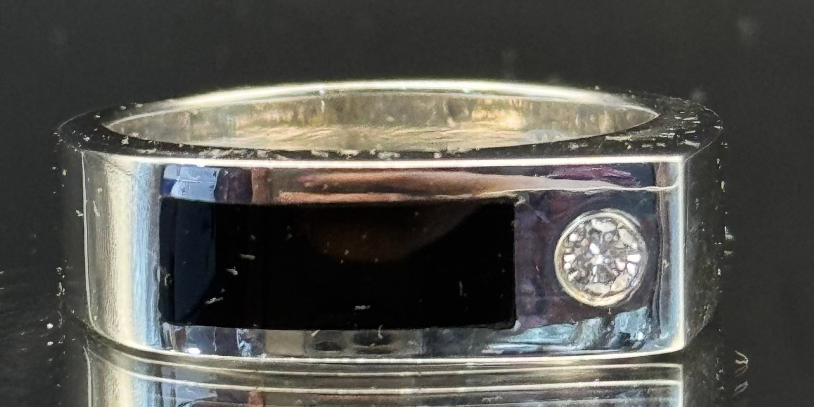 Vintage 14k White Gold Onyx & Natural Diamond Ring | 10.8g | Size 9.5: A regal and sophisticated vintage classic. This sleek statement ring is crafted in 10.8 grams of solid 14k white gold, featuring a smooth polished surface inlaid with a striking black onyx strap. A 0.
