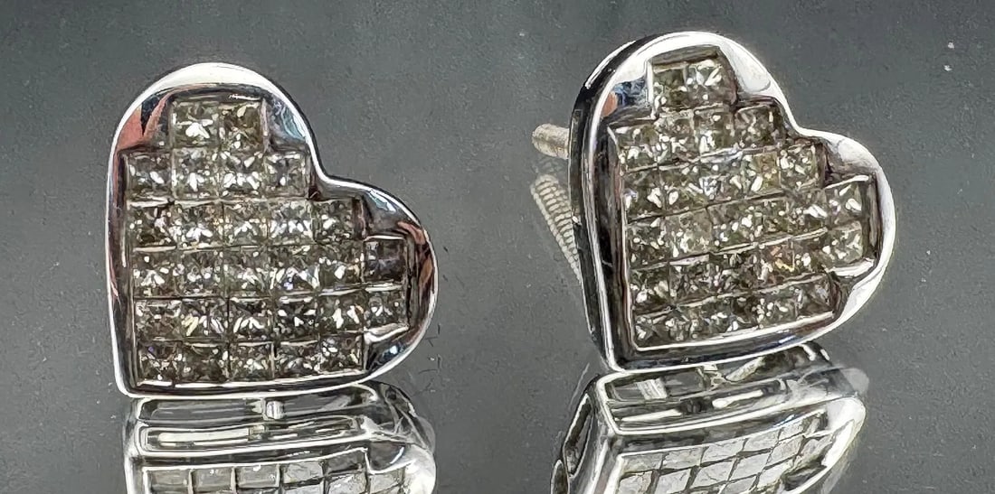 14K WHITE GOLD PRINCESS DIAMOND CLUSTER HEART STUD EARRINGS 1.75CT: 14K white gold diamond cluster heart stud earrings featuring 1.75ct princess cut earth-mined diamonds, G color, VS2/SI1 clarity, invisible set. 28 diamonds per earring. Screw-back closure. Total weigh