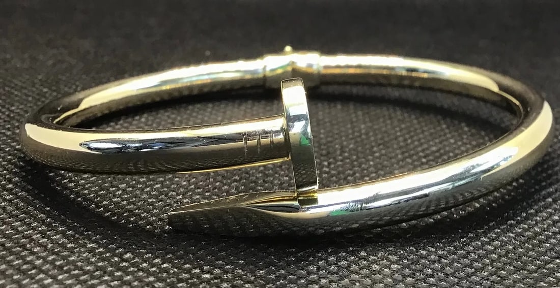 14K YELLOW GOLD CARTIER INSPIRED NAIL BANGLE BRACELET: 14K yellow gold Cartier inspired nail bangle bracelet. Simple and elegant design suitable for any attire. High polish finish. Total weight 12.4 grams, measures 2¾ inches. Stamped 14K. New condi