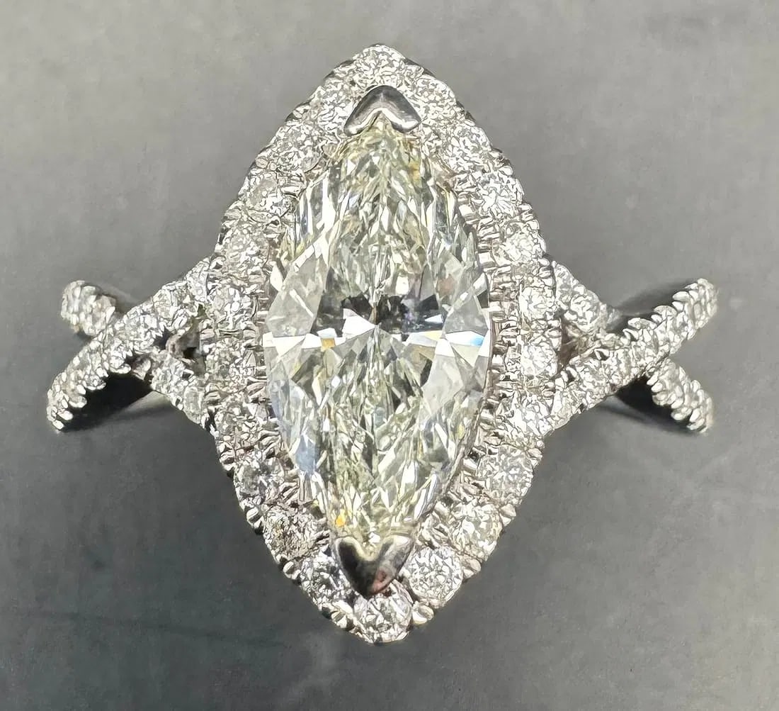 14K WHITE GOLD MARQUISE DIAMOND RING IGI CERTIFIED 1.58CT: 14K white gold ring featuring a 1.07ct marquise cut earth-mined diamond center stone, J color, VS2 clarity, IGI certified, set in 2 prong setting. Side stones feature 0.51ct round brilliant cut earth-