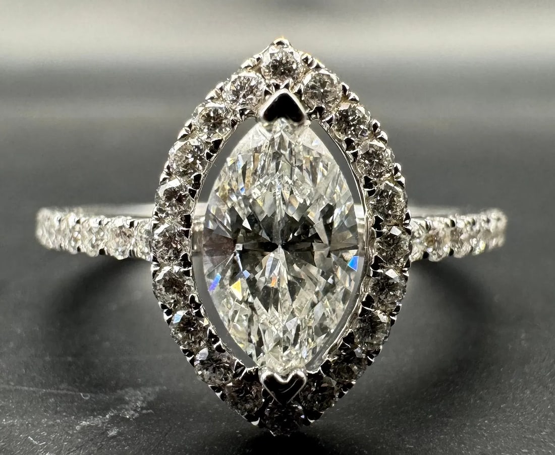 18K WHITE GOLD MARQUISE DIAMOND RING EGL CERTIFIED 1.14CT: 18K white gold ring featuring a 0.70ct marquise cut earth-mined diamond center stone, H color, SI3 clarity, EGL certified, set in prong setting. Side stones feature 0.44ct round brilliant cut earth-mi