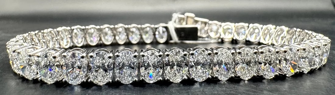14K WHITE GOLD LAB DIAMOND OVAL CUT TENNIS BRACELET 16.75CT: 14K white gold tennis bracelet featuring 41 oval cut lab-grown diamonds totaling 16.75ct, E-F color, VS clarity, set in 4 prong setting. Continuous sparkle throughout entire bracelet. Double safety cl