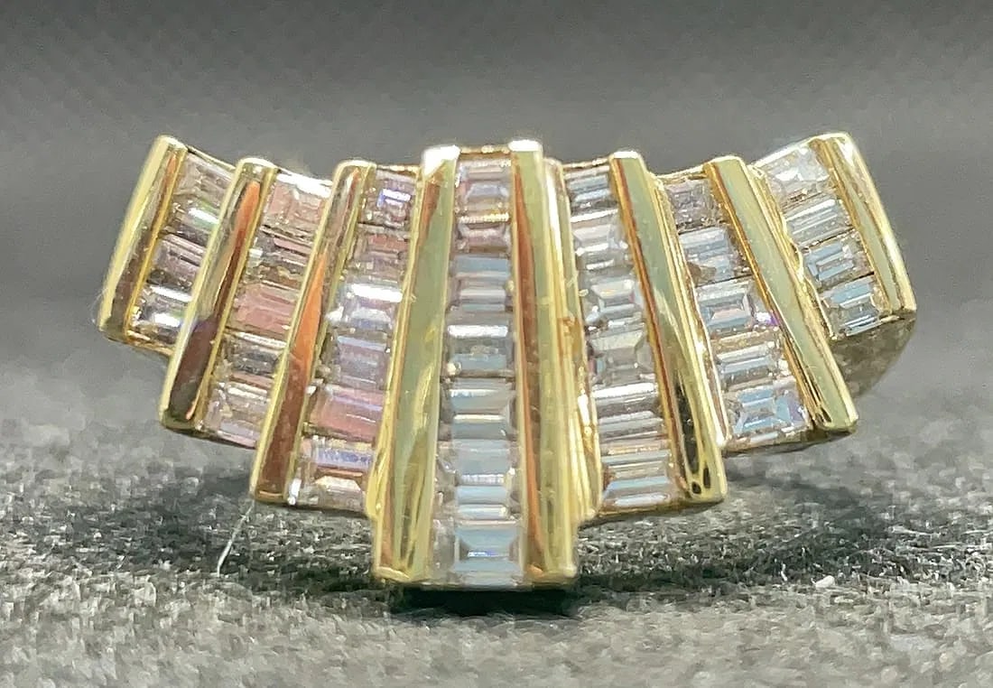 14K YELLOW GOLD 1.50CTW BAGUETTE DIAMOND RING: Stunning 14K yellow gold right-hand statement ring featuring 1.50 carats total weight of baguette cut earth-mined diamonds. The center features an illuminating setting designed to brighten and elongat