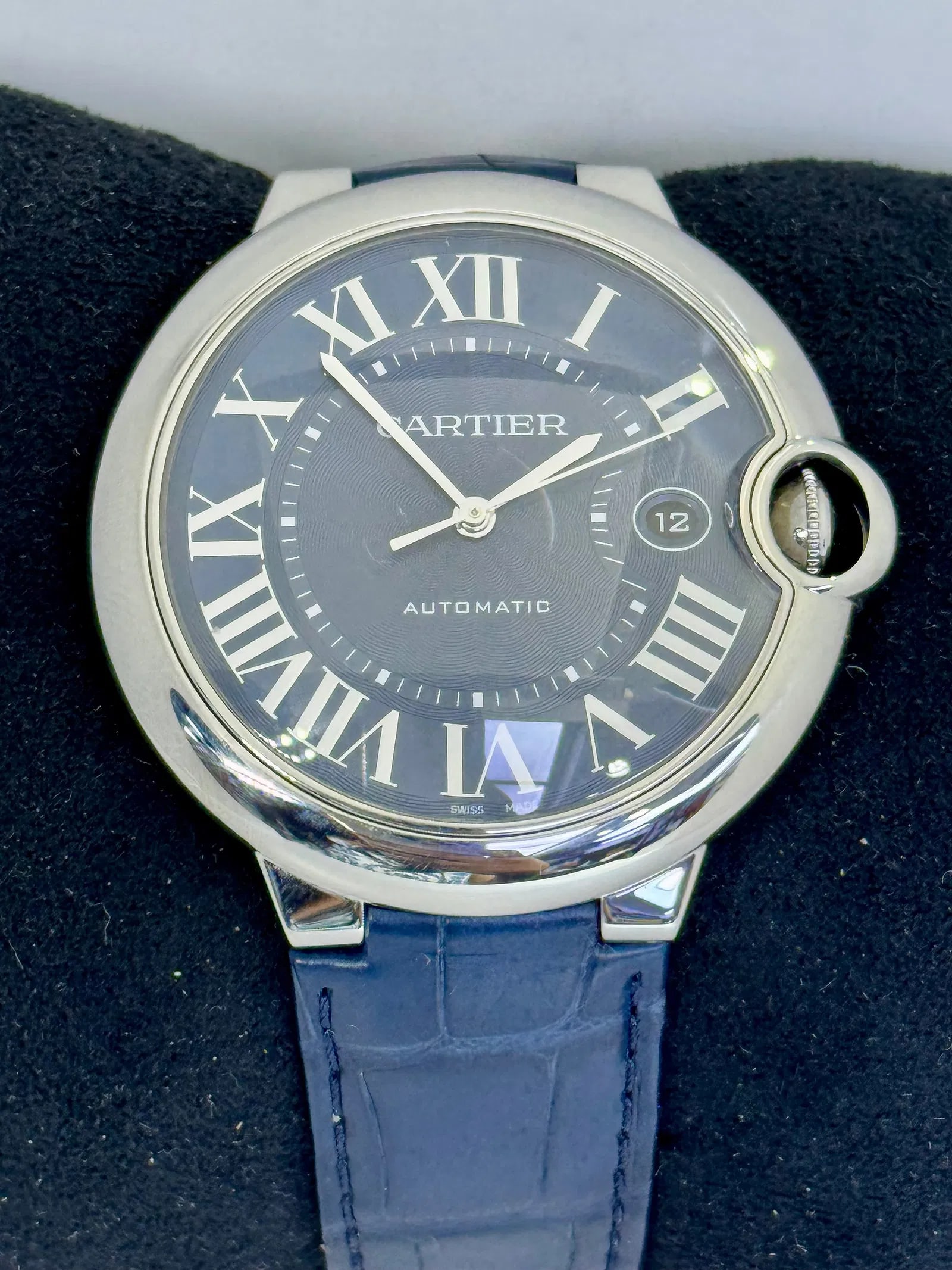 CARTIER BALLON BLEU 42MM AUTOMATIC WATCH: Stunning 42mm Cartier Ballon Bleu in stainless steel featuring a refined blue guilloche dial with signature Roman numerals and a date aperture at 3 o clock. This timepiece is powered by a reliable Car