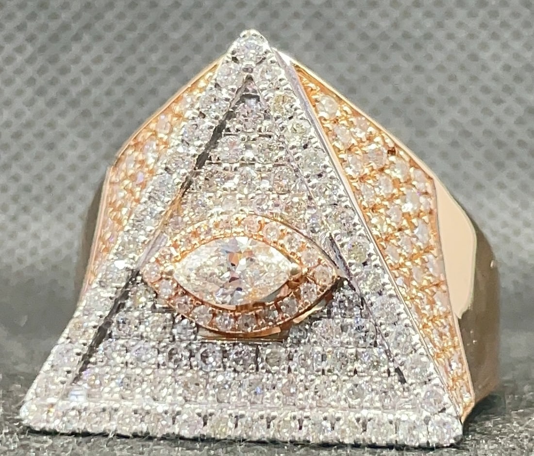 14k Two-Tone Rose & White Gold 2.89ctw Custom Pavé Diamond Ring (12.69g): Make a definitive statement with this masterfully crafted custom "Eye" design men's ring. The piece is forged in solid 14k two-tone gold and features a striking marquise diamond center, set in rose go