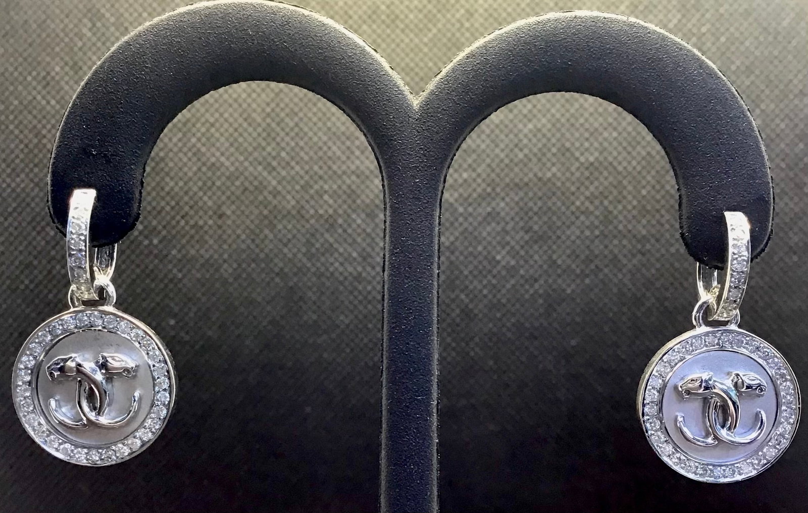14k White Gold 0.50ctw Art Deco Panther Disc Drop Earrings (9.2g): These one-of-a-kind Art Deco-inspired drop earrings offer a bold and artistic statement. The design features a polished 14k white gold round disc with two intricately engraved panther heads, encircled