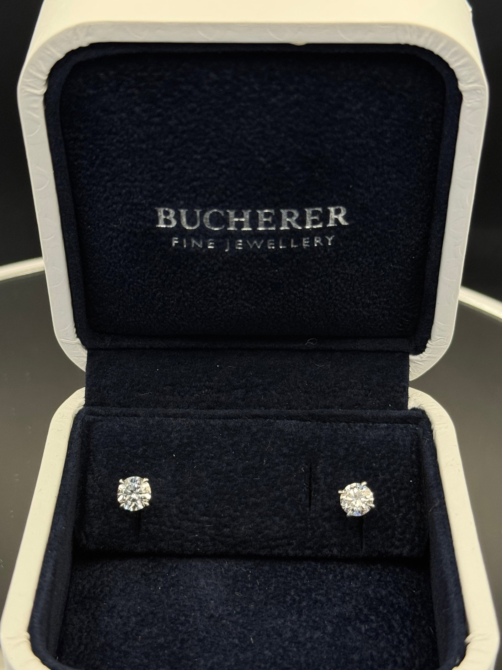 Bucherer 1.10ctw E-Color VS1 Diamond Studs | 14k White Gold | Full Set w/ Box: Elevate your collection with these elite-grade diamond studs from the legendary Bucherer Company. Featuring 1.10ctw of natural earth-mined round brilliant diamonds, these stones boast a rare E color (