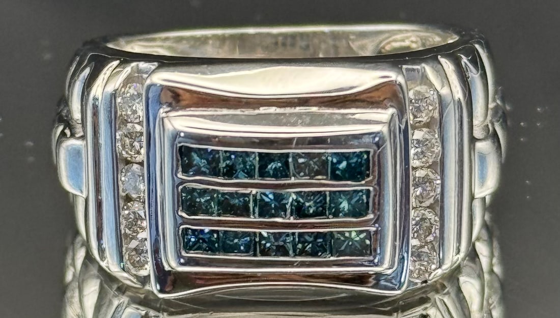 Men's 1.50ctw Blue & White Diamond Statement Ring | 14k White Gold (13.6g): A bold and contemporary design featuring a striking contrast of colors. This substantial 14k white gold ring showcases 1.50 carats of natural earth-mined diamonds. The center features vibrant blue pri