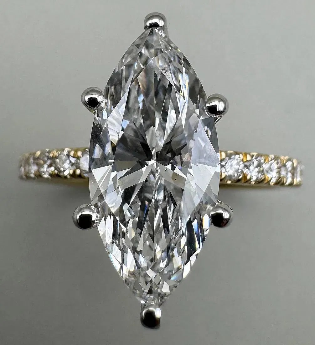 14K TWO-TONE GOLD 2.85CT IGI CERTIFIED MARQUISE CUT LAB DIAMOND RING: Special Opportunity: This lot features a set reserve of $2100. This is significantly below the estimated retail replacement value, offering a unique opening for everyone.14K two-tone gold ring featuri