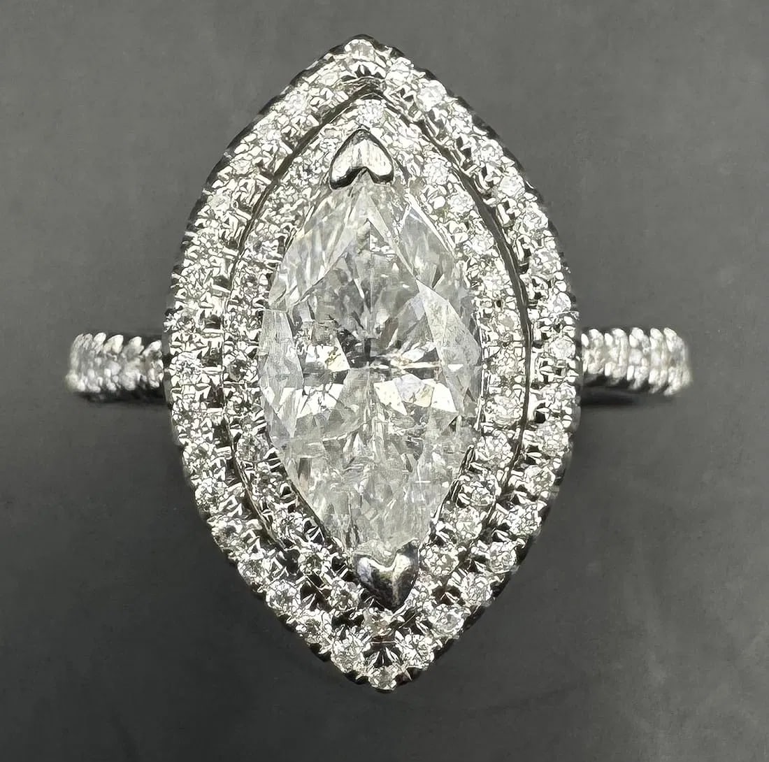 14K WHITE GOLD MARQUISE DIAMOND RING 1.91CT: 14K white gold ring featuring a 1.30ct marquise cut earth-mined diamond center stone, F-G color, SI2/I1 clarity, set in 2 prong setting. Side stones feature 0.61ct round brilliant cut earth-mined diam