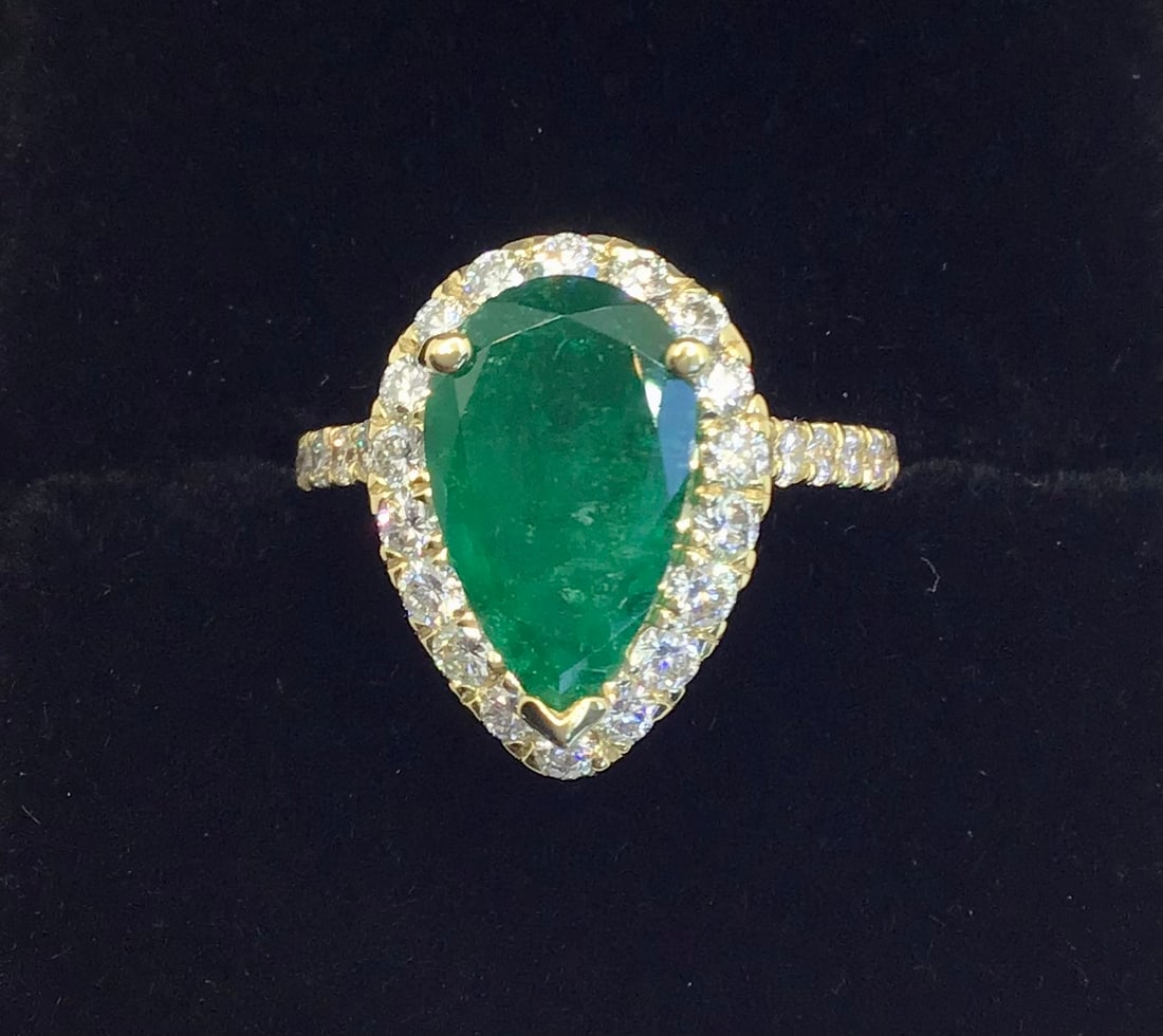 14k Yellow Gold 3.00ct Pear-Cut Natural Emerald & 1.00ctw Diamond Halo Ring (4.9g): This one-of-a-kind stunning 14k yellow gold ring is a masterpiece of color and brilliance. The focal point is a magnificent 3.00-carat genuine pear-shaped natural green emerald, radiating a deep and v