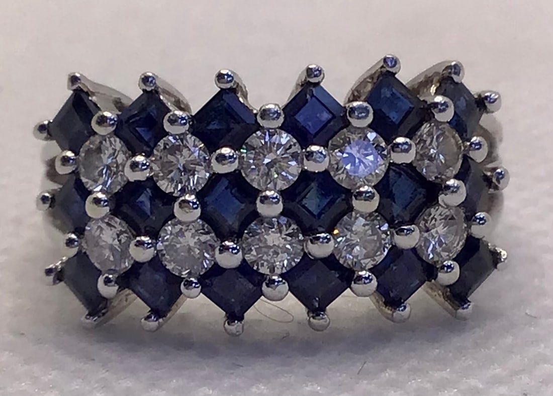 14k White Gold 0.50ctw Princess-Cut Sapphire & 0.50ctw Diamond 5-Row Band (3.8g): This stunning 14k white gold cocktail ring features a sophisticated five-row design with a unique aesthetic twist. The piece showcases three rows of vibrant princess-cut sapphires totaling 0.50 carats