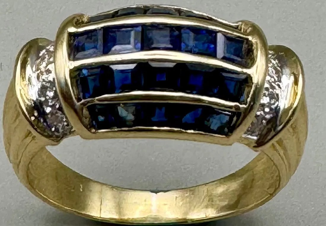 18K YELLOW GOLD SAPPHIRE DIAMOND RING 1.50CT SAPPHIRE 0.30CT DIAMOND: 18K yellow gold ring featuring 1.50ct princess cut sapphires and 0.30ct round brilliant cut earth-mined diamonds set halfway around band in invisible setting. Diamonds F-G color, VS clarity. Total rin