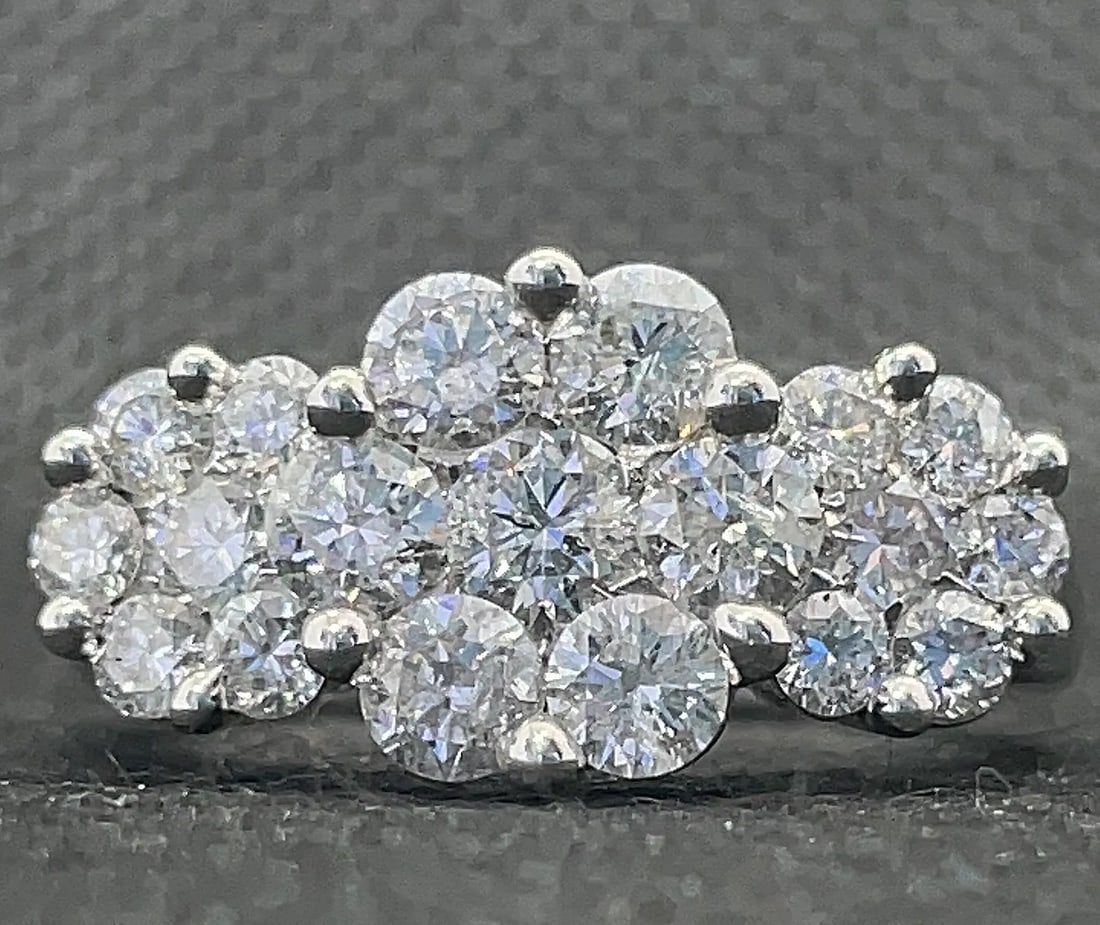 14K WHITE GOLD 3.00CTW ROUND DIAMOND FLORAL RING: Unique 14K white gold ring featuring a three-flower floral arrangement of round brilliant cut diamonds totaling 3.00 carats. The center features high-set glittering clusters with a sophisticated thick