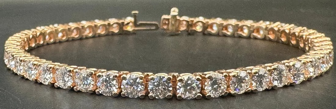 10K ROSE GOLD 14.50CT LAB GROWN DIAMOND BRACELET: Luxurious 10K rose gold tennis bracelet featuring 45 round brilliant cut lab-grown diamonds in a secure 4-prong setting. The continuous line of diamonds totals an impressive 14.50 carats, boasting exc