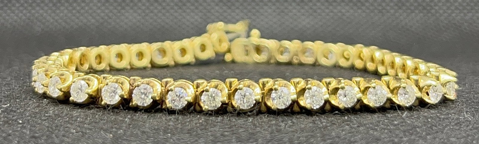 14k Yellow Gold 3.65ctw Round Brilliant Diamond Tennis Bracelet (18.2g): Elevate your collection with this elegant staple piece, a classic ladies' tennis bracelet crafted in solid 14k yellow gold. The bracelet features 40 genuine, earth-mined round brilliant diamonds with 