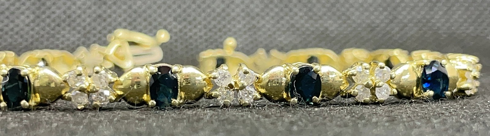 14k Yellow Gold 4.00ctw Sapphire & 1.75ctw Diamond Bracelet (12.1g): This classic and elegant bracelet is masterfully handcrafted in 14k yellow gold, featuring a sophisticated alternating design of gemstones and diamonds. The piece is set with 4.00 carats total weight 