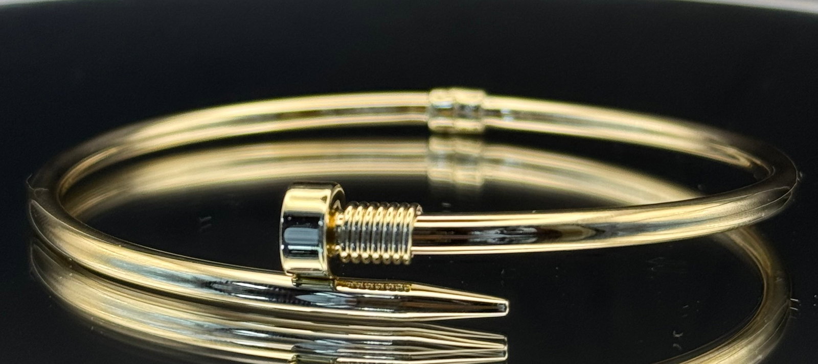 14k Yellow Gold Modern Flexible "Nail" Motif Bangle Bracelet (5.5g): A chic, high-fashion statement with an industrial-inspired edge. This modern bangle is masterfully crafted in solid 14k yellow gold and features a unique flexible design, allowing for effortless wear 