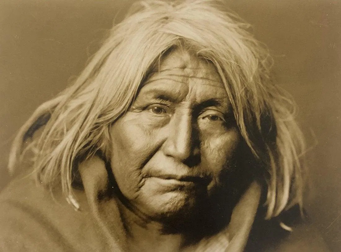 EDWARD CURTIS (1868-1952): Portrait of Apache Woman Printed in colors mounted on archival board 8" x 10 3/4"