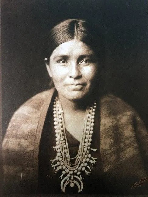 EDWARD CURTIS (1868-1952): A Navajo Woman Printed in colors mounted on archival board 8 1/2" x 6 1/2"