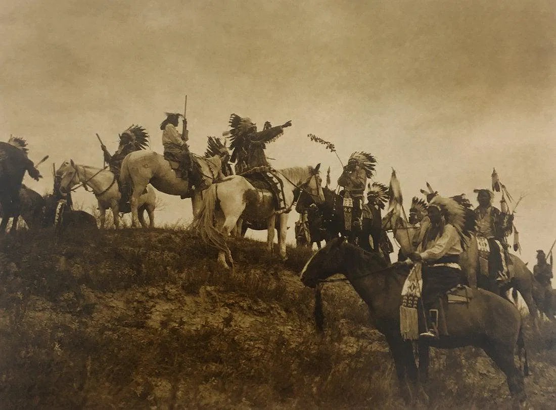 EDWARD CURTIS (1868-1952): Planning a Raid, Oglala Sioux Printed in colors mounted on archival board 8" x 10 3/4"