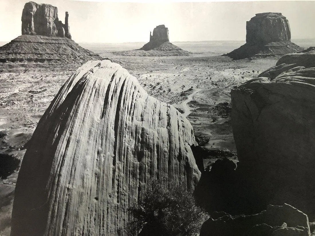 ANSEL ADAMS (B. 1902-1984): Monument Valley, Utah Printed in colors mounted on archival board 11 1/2" x 15"