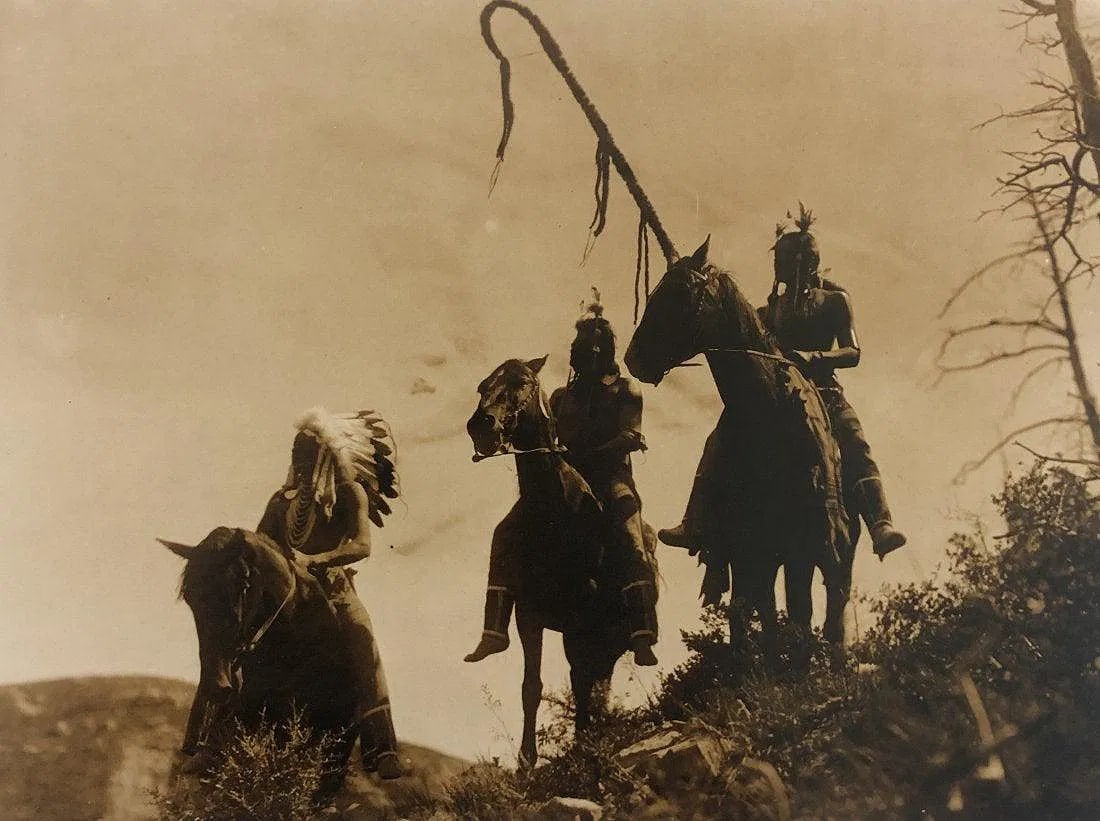 EDWARD CURTIS (1868-1952): Apsaroke War Group Printed in colors mounted on archival board 8" x 10 1/2"