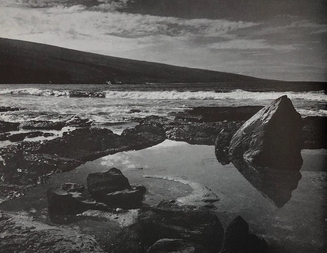 ANSEL ADAMS (B. 1902-1984): Lava rock and surf, Hookena, Hawaii Printed in colors mounted on archival board 6"x 7 1/2"