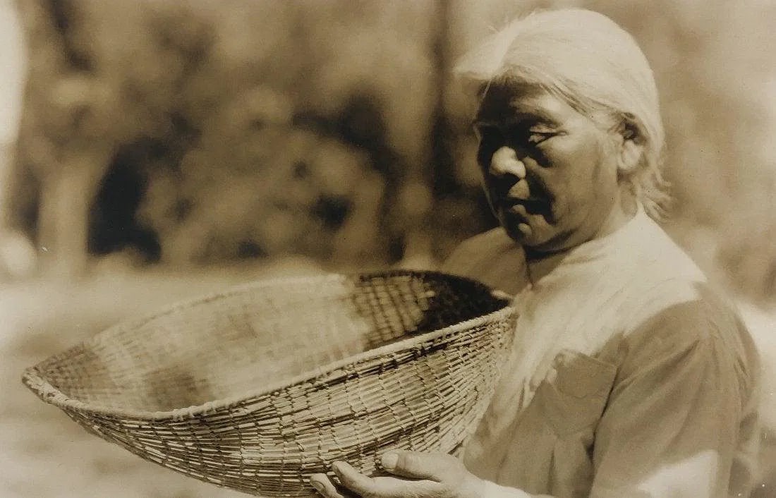 EDWARD CURTIS (1868-1952): Basket Weaver Printed in colors mounted on archival board 8" x 12"