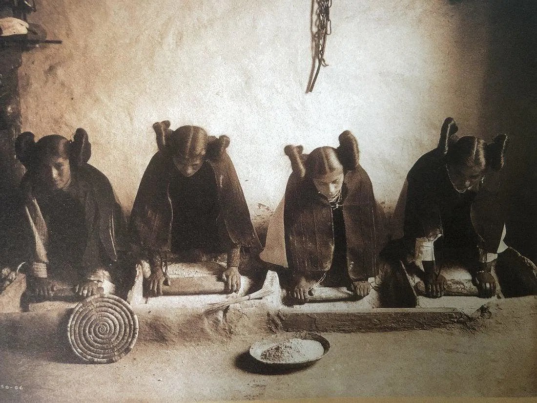 EDWARD CURTIS (1868-1952): Hopi Girls Grinding Peke Bread Meal, Printed in colors mounted on archival board 6" x 7 1/2"