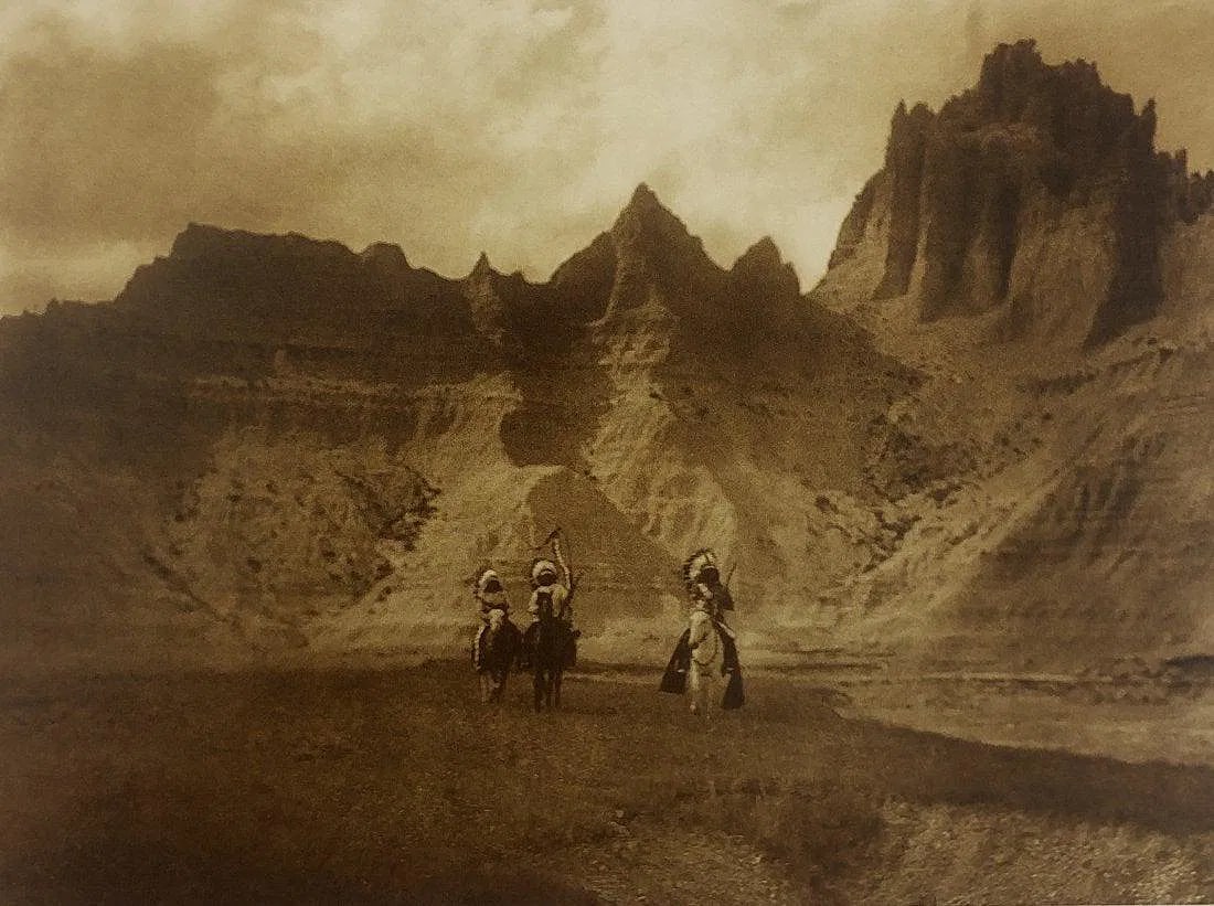 EDWARD CURTIS (1868-1952): In the Bad Lands, South Dakoda Printed in colors mounted on archival board 8" x 10 1/2"