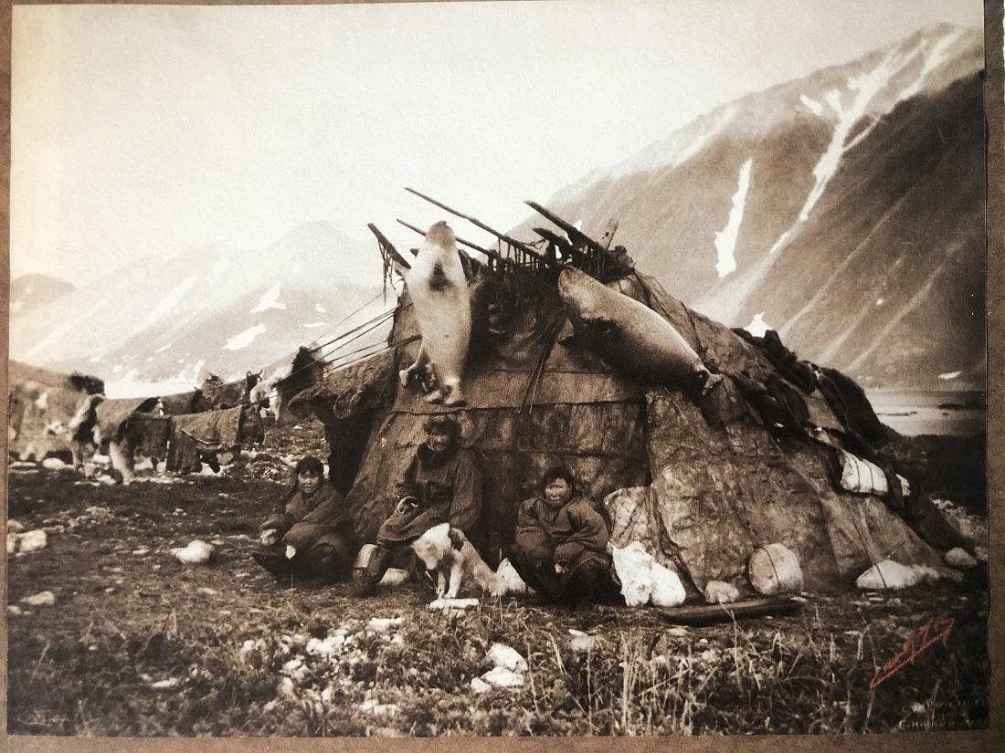 EDWARD CURTIS (1868-1952): Inuit Hut and Family, Printed in colors mounted on archival board 6" x 7 1/2"