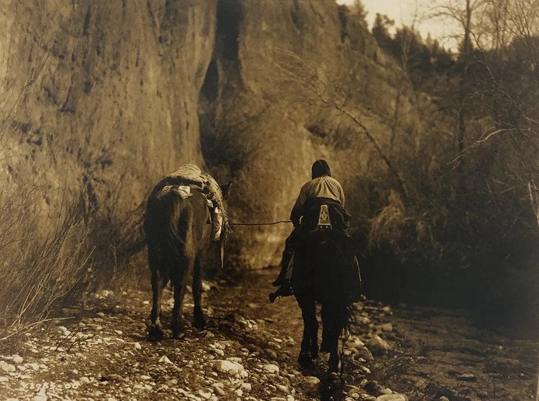 EDWARD CURTIS (1868-1952): Moving Apsaroke Printed in colors mounted on archival board 8" x 10 3/4"