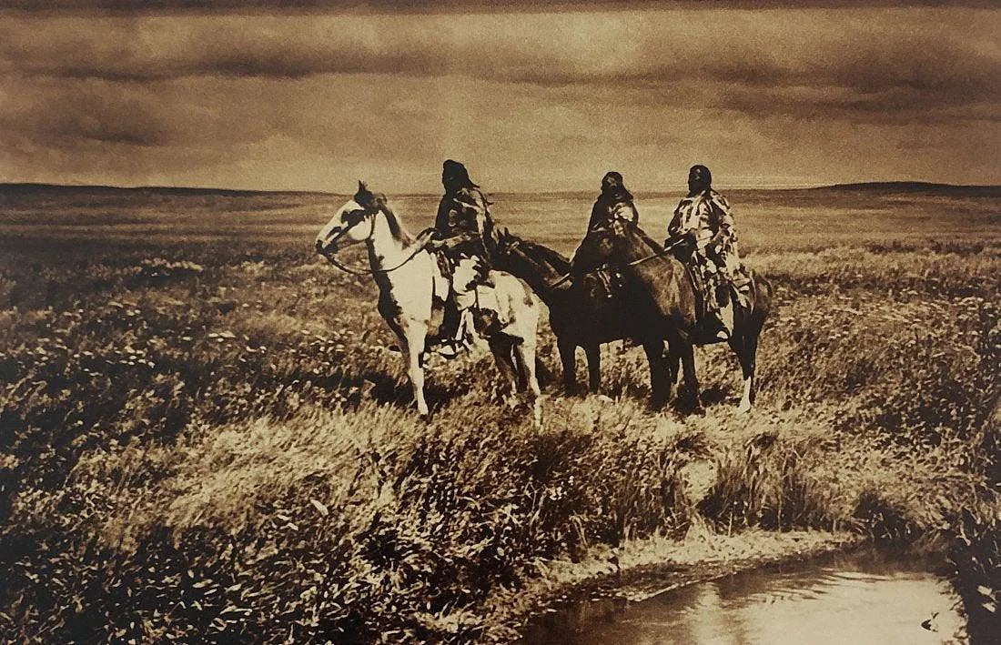 EDWARD CURTIS (1868-1952): The Three Chiefs Piegan Printed in colors mounted on archival board 8" x 12"