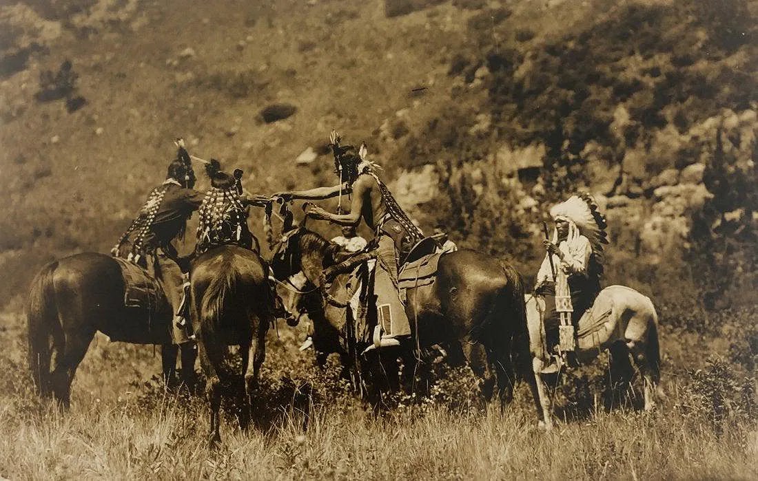 EDWARD CURTIS (1868-1952): Tribesmen on Horseback, Printed in colors mounted on archival board 8" x 12"