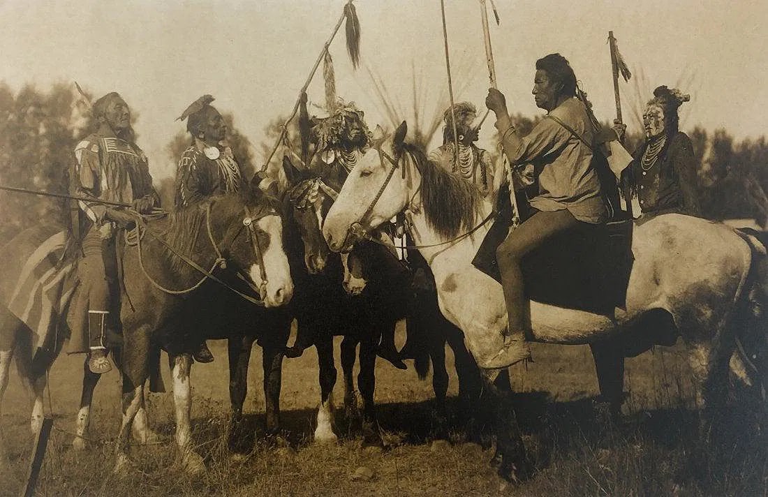 EDWARD CURTIS (1868-1952): Tribesmen on Horseback, Printed in colors mounted on archival board 8" x 12"