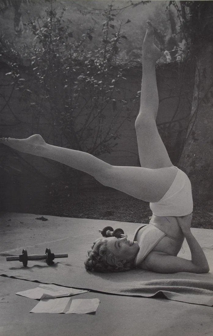 ANDRE De DIENES (1919-1985): Marilyn Monroe Working Out, Printed in colors mounted on archival board 12" x 7 1/2"