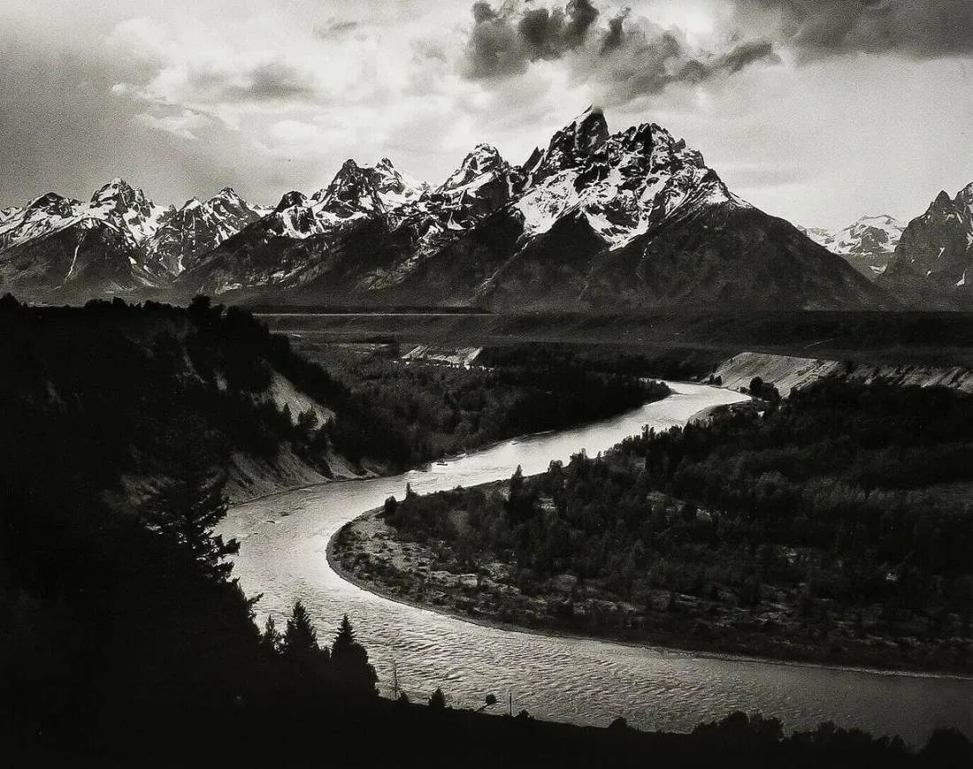 ANSEL ADAMS (AMERICAN) PRINT ON PAPER: Ansel Adams (American). Grand Tetons and Snake River, Wyoming (1942). Printed in USA in 1972 and Published by Rapoport Printing Company. Measures 6.25 x 7.75 inches. Semi-gloss.