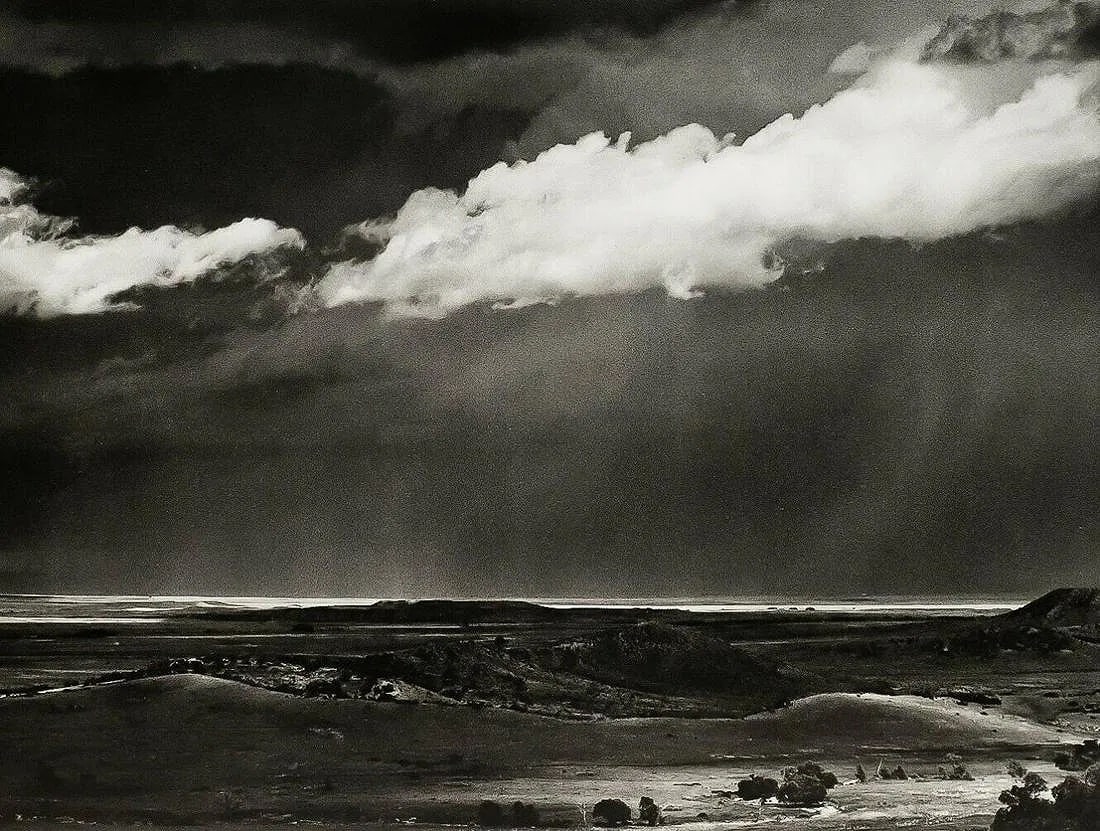ANSEL ADAMS (AMERICAN) PRINT ON PAPER: Ansel Adams (American). Storm Over the Great Plains from Cimarron (1960). Printed in USA in 1972 and Published by Rapoport Printing Company. Measures 5.75 x 7.50 inches. Semi-gloss.