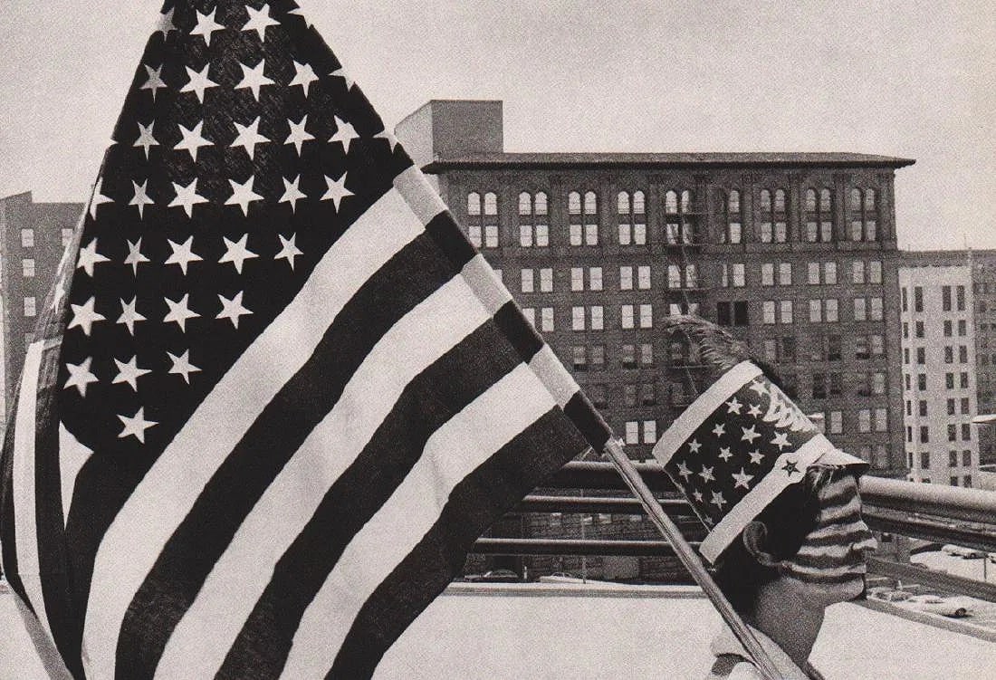 BURK UZZLE (AMERICAN) PRINT ON PAPER: Burk Uzzle (American) Print on Paper. Parade, Los Angeles (1976). Printed in France in 1985. Measures 8.50 x 6.00 inches. Gravure.