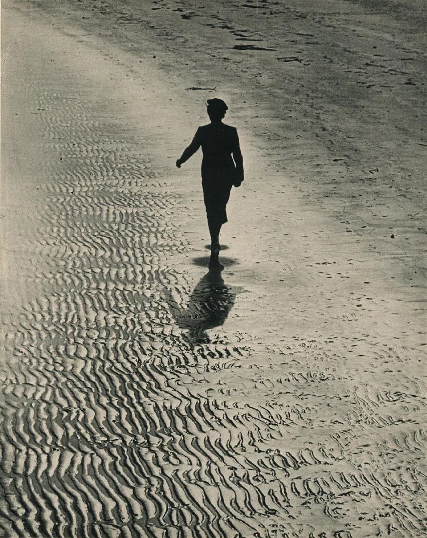 ALFRED EISENSTAEDT (AMERICAN) PRINT ON PAPER: Alfred Eisenstaedt (American) Print on paper. Girl Walking on Sands. Printed in New York in 1937. 10.00 x 12.50 inches.