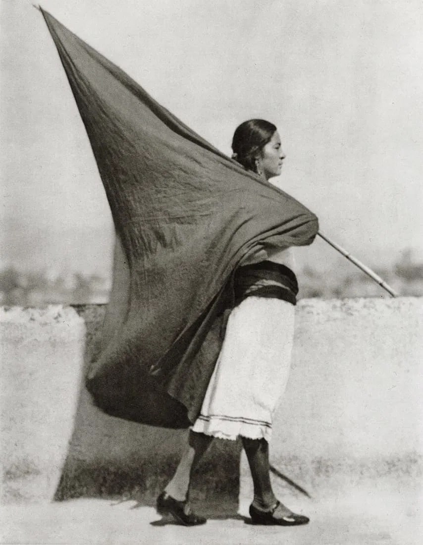 TINA MODOTTI (ITALIAN) PRINT ON PAPER: Tina Modotti (Italian) Print on Paper. Woman with Flag, Mexico City (1928). Printed in China in 1999. Measures 5.65 x 7.25 inches.