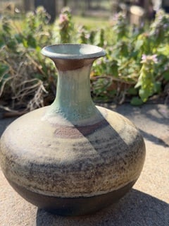 Mid-Century Studio Pottery Bottle Vase, Signed Monogram: Mid-century studio pottery bottle vase with a rounded body and tall flared neck. The piece is hand-thrown stoneware and finished with layered natural glazes, including a soft celadon-green glaze at th