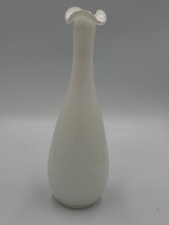 Mid-Century Scandinavian Style White Opaline Art Glass Vase, 1960s: Mid-century art glass vase featuring a tall, slender form with a flared and ruffled rim. Executed in white opaline glass with subtle vertical optic patterning, the piece reflects the clean, organic ae